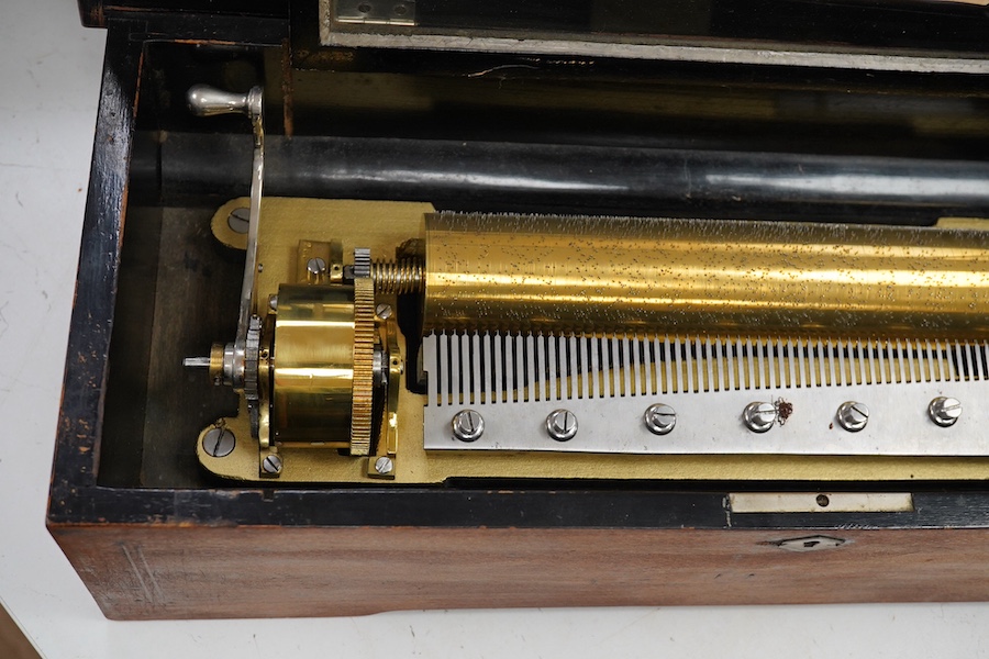 A late 19th century Swiss rosewood ten air cylinder music box, with inlaid lid decorated with musical instruments and foliage, paper label listing the airs to inside of lid, with sixty two tooth comb, cylinder 28cm, case